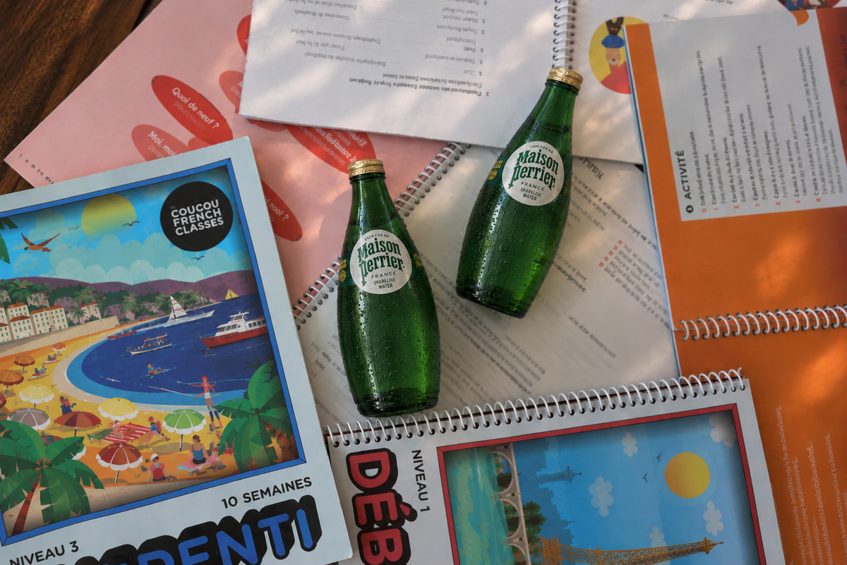 Bottles of Maison Perrier with Coucou coursebooks