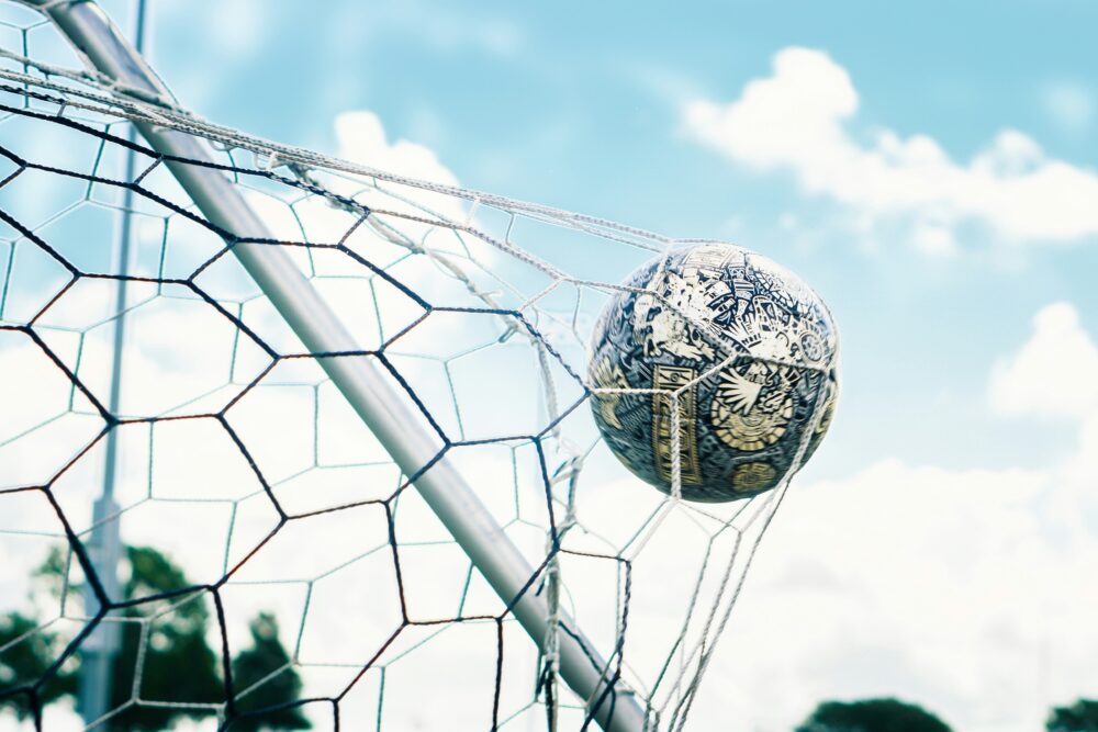 A ball goes in the net at a football match