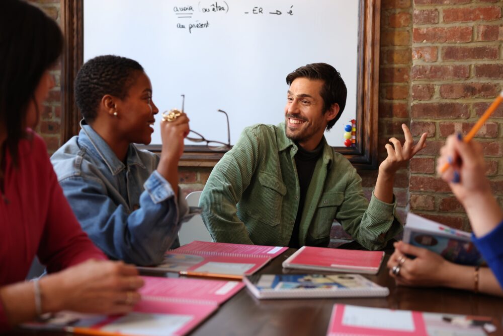 teacher ans students are having a good time speaking French
