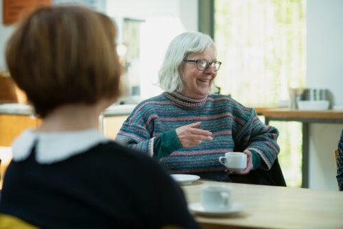 two people talking over coffee